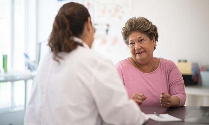 An older woman having a discussion with her doctor.