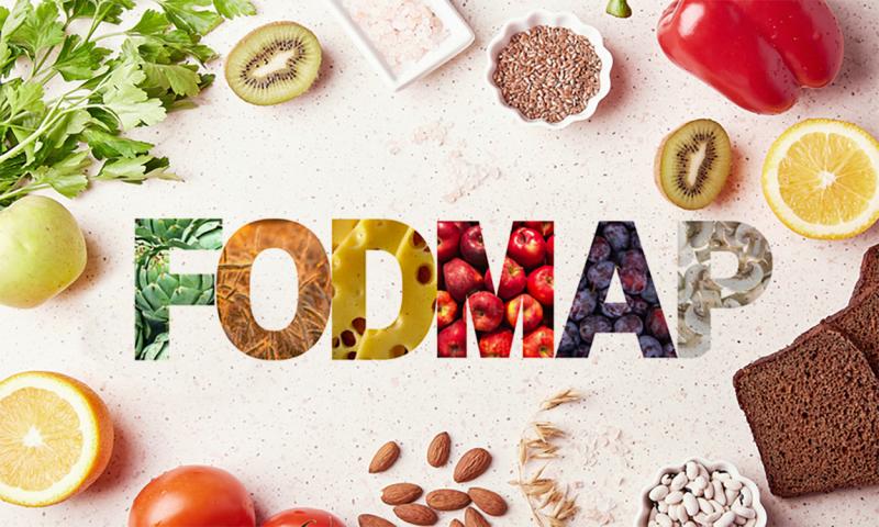 Variety of healthy foods on a kitchen counter with the text “FODMAP” in the center.