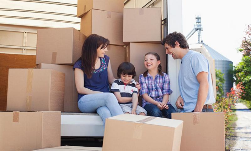 Multi-ethnic family unloading a moving truck.