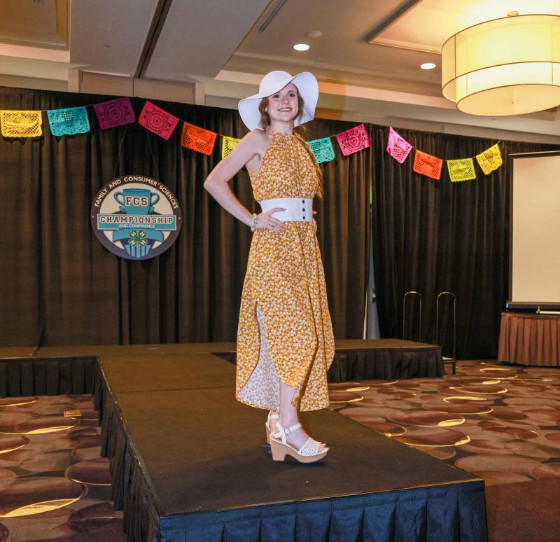 Sophia Sudenga models her yellow floral outfit on the runway at the national FCS Fashion Revue contest
