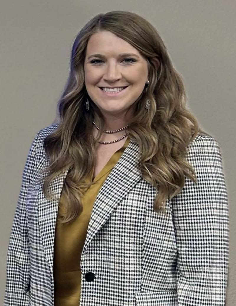 Erin DeHaan smiles at the camera for a portrait