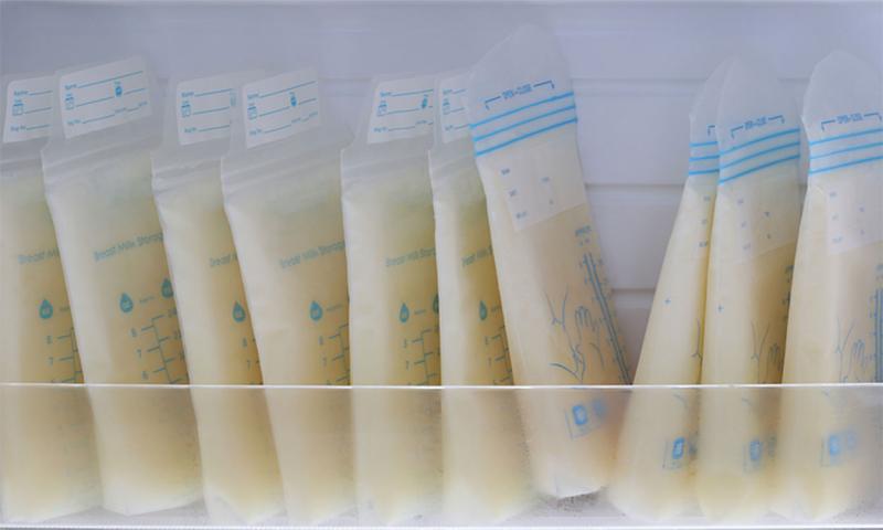 Several bags of breastmilk being stored in a refridgerator.