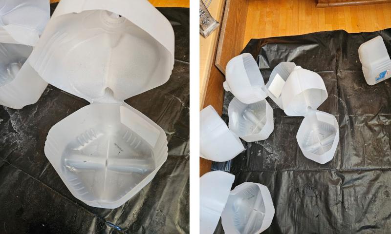 Gallon jugs cut open with a space left at the handle for a hinge.