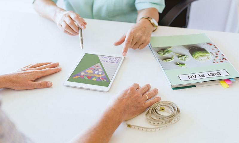 Dietician reviewing a diet plan with a client.