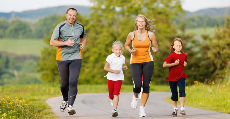 Family jogging together on a rural exercise trail.