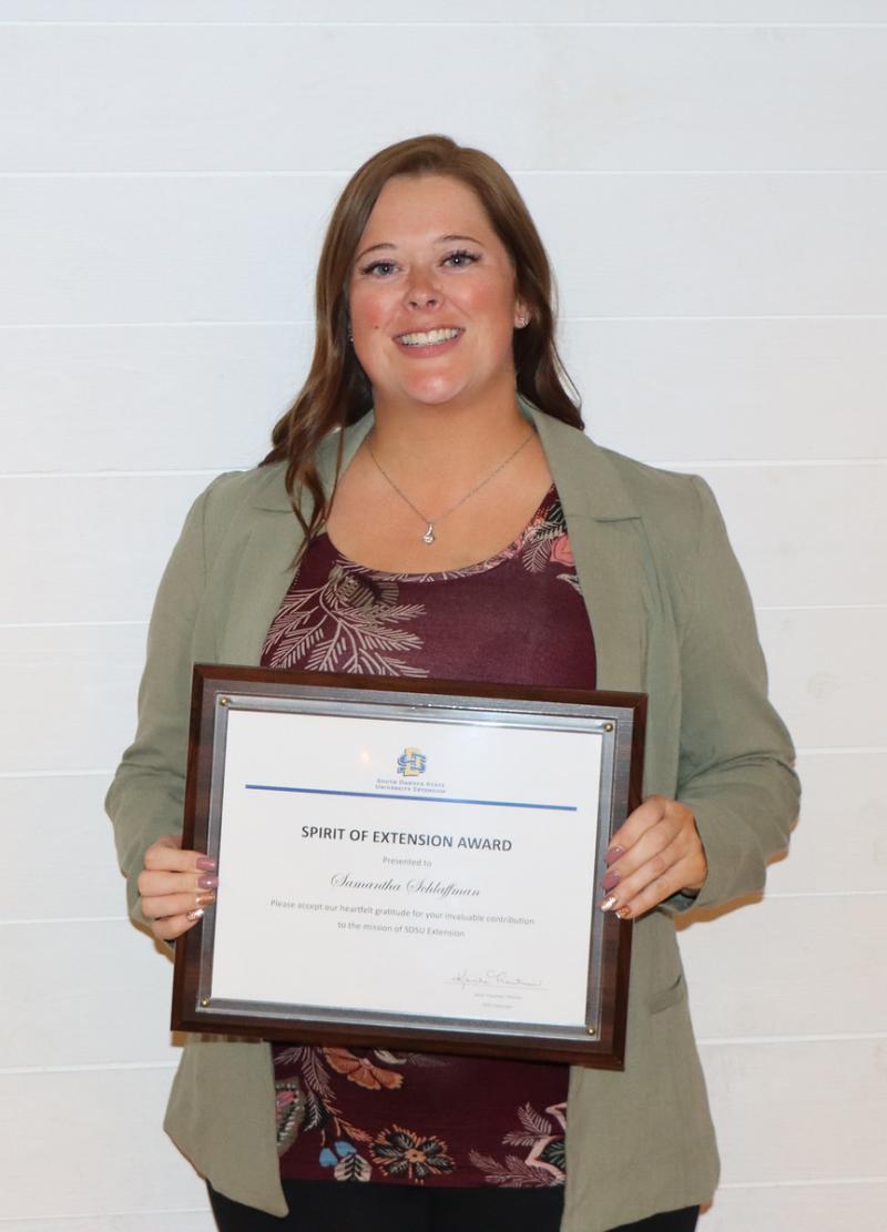 Samantha Schlaffman holds up her plaque