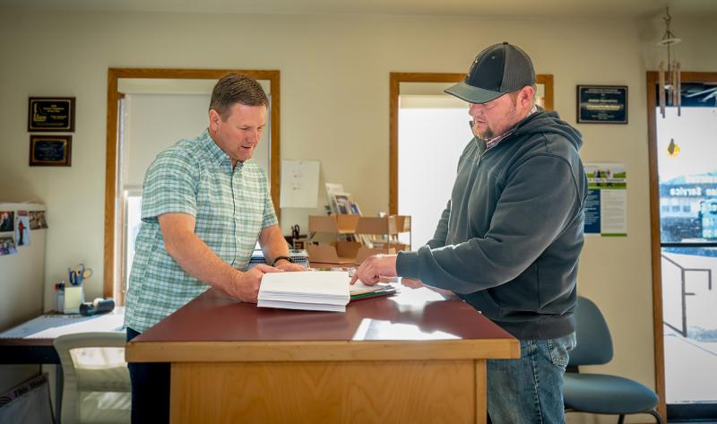 Producer reviewing paperwork with an insurance agent.