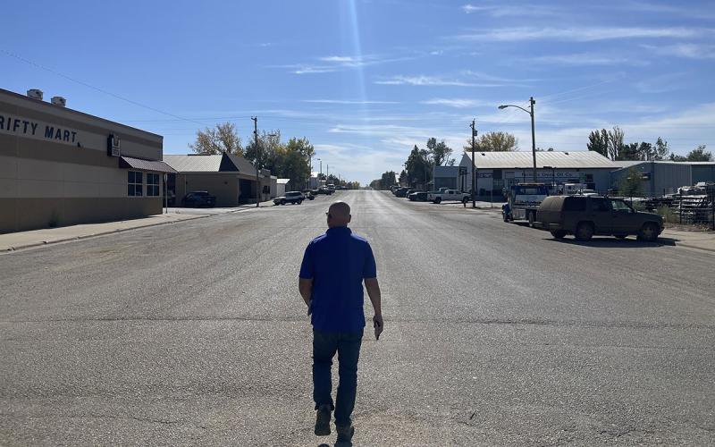 A man walking down a street in the community of Dupree, South Dakota.