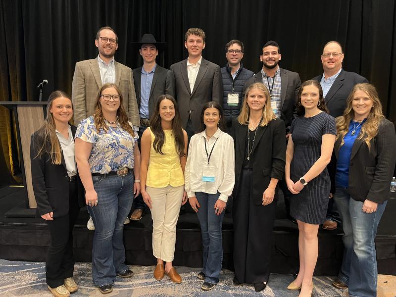 A group of people smiles for the camera