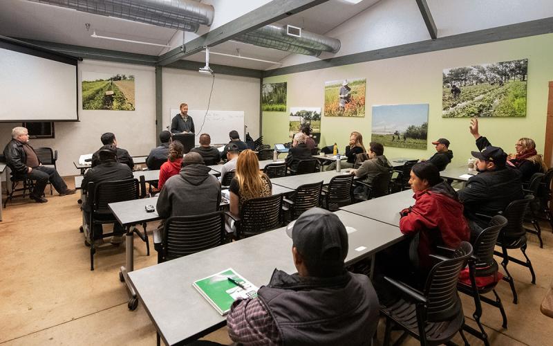 Attendees taking a proctored exam in an agriculture classroom.