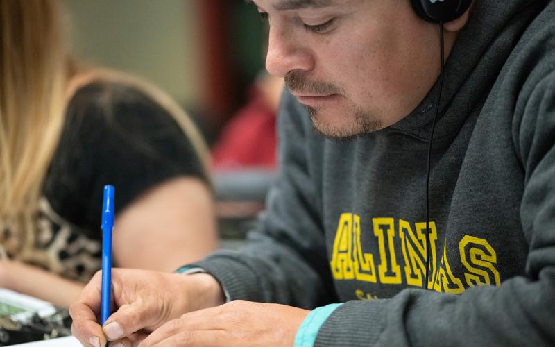 Attendee taking a proctored exam in an agriculture classroom.