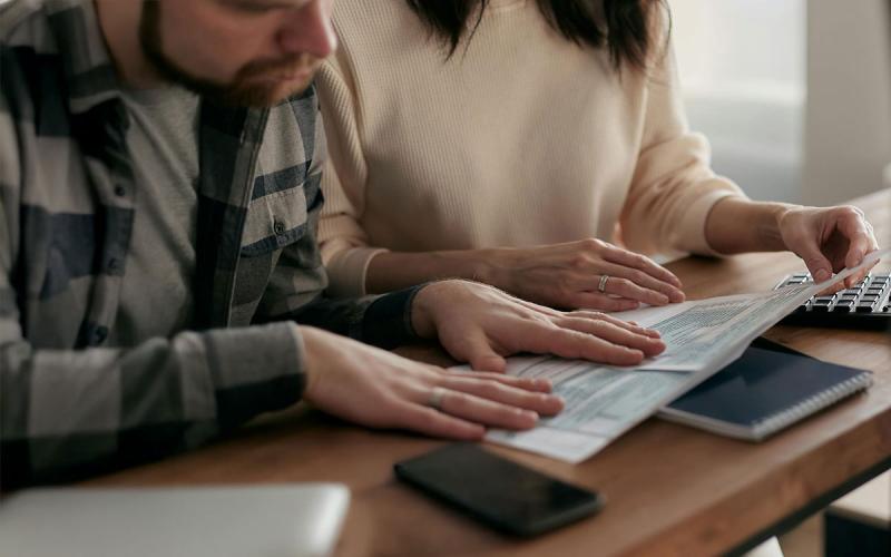Husband and wife reviewing financial resources.