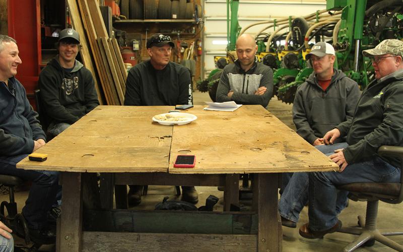 Group of farm employees and managers gathered at a table.