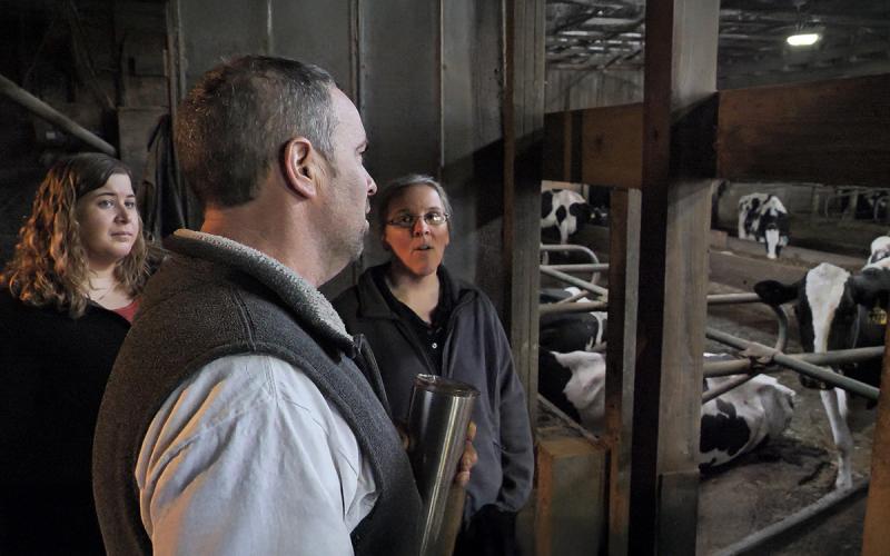 Dairy manager and USDA agents touring a dairy facility.