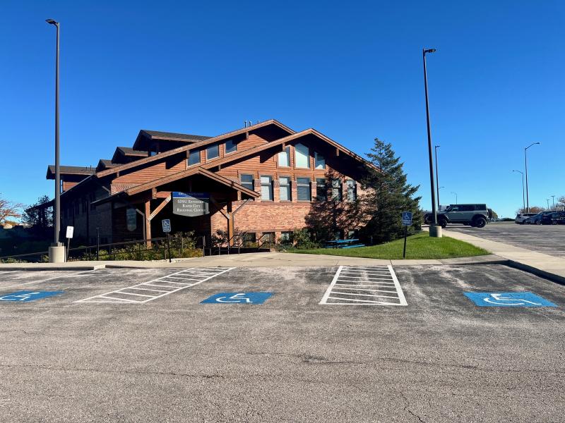 brown office building near a parking lot
