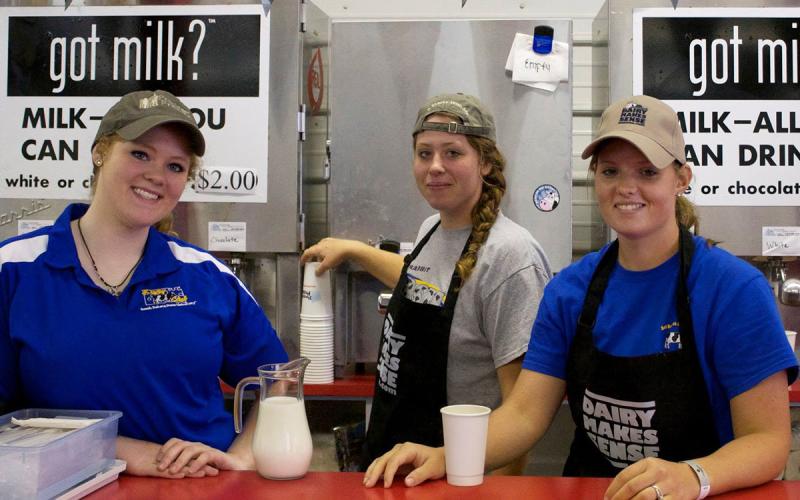 Group of SDSU Dairy Club members serving “all you can drink milk” at an event.