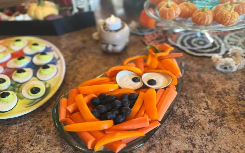 Variety of healthy Halloween snacks arranged on a countertop.