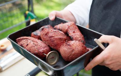 steaks in a pan with a meat thermometer