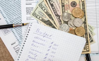 budget sheet with money and bills