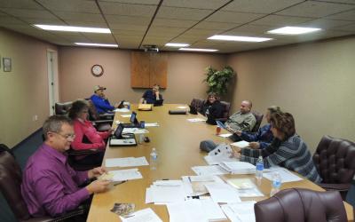 A group of people meeting at a conference table.