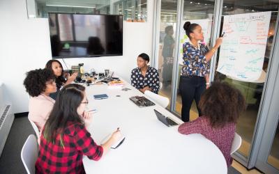 A group of employees working as a team at a meeting.