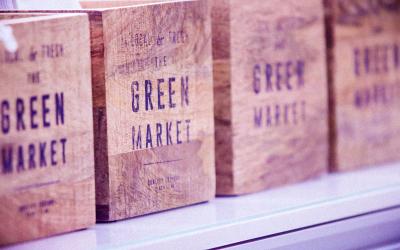 A row of CSA subscription boxes with the words Green Market printed on them.