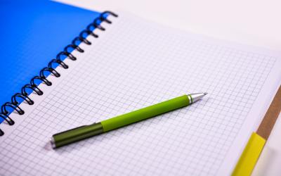 A notebook with a pen sitting on it.