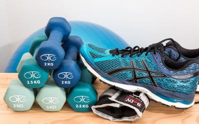 athletic shoe next to stack of small weights