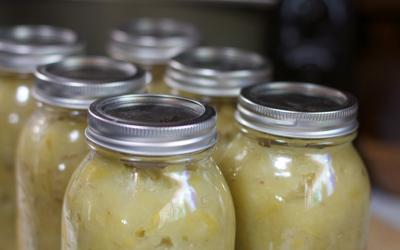group of sealed canning jars on table