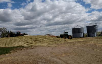 tractor near pile of harvested silage