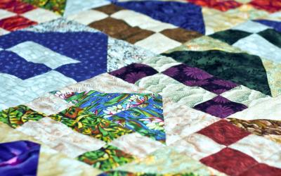 a homemade quilt with various pattern blocks