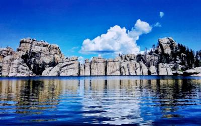 granite rock formation surrounding a lake.