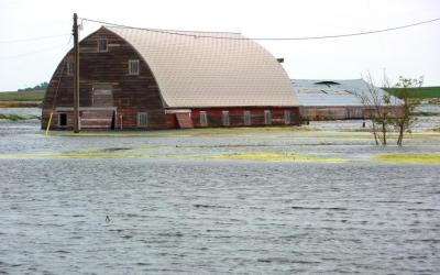 abandoned barn surrounded by flood waters. Photo by Jeannie Mooney, FEMA