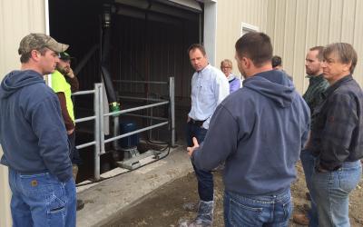 group of dairy workers observing manure storage facility. Photo by Kari Cohen, NRCS.