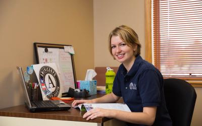 Female volunteer smiling at her desk