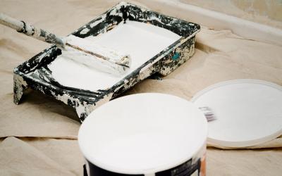 a paint roller, paint tray and bucket of pain