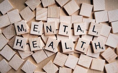 scrabble tiles arranged to spell mental health