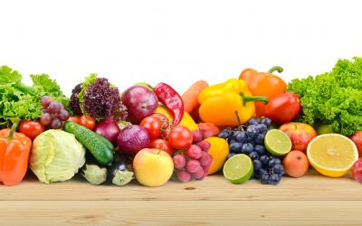 A variety of fresh fruits and vegetables displayed on a countertop.