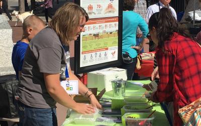 Woman at a booth demonstrating beef sustainability.