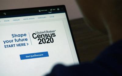 A person visiting the U.S. Census website on a laptop computer.