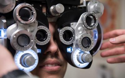 A young man receiving an optometry examination.