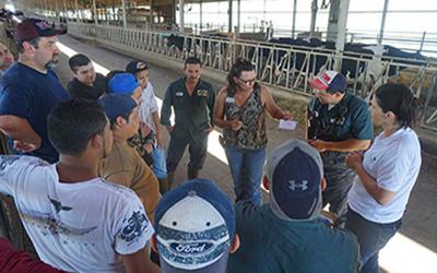 Dairy Farm Employees gather around at a formal training meeting on a dairy farm to learn new information. Courtesy: Heidi Carroll