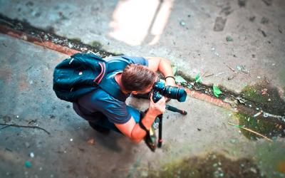 a man taking a photo with a camera on a tripod