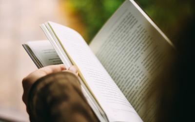 a person opening a book
