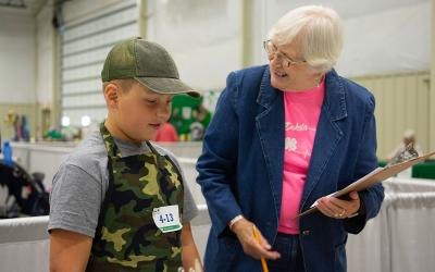4-H volunteer talking to a 4-H youth.
