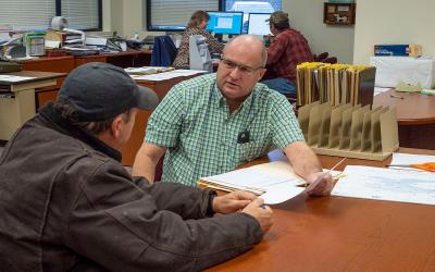 Producer reviewing an aid application with a USDA FSA agent.