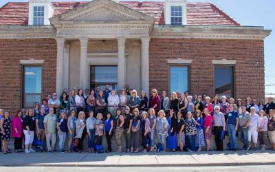 2021 Energize! Conference attendees gathered outside a brick building.