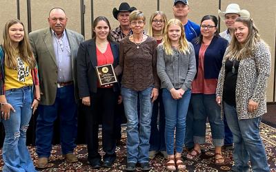 Clements Ranch staff accepting their Master Lamb Producer award from SDSU Extension's Kelly Froehlich.