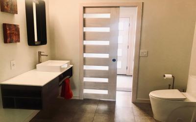 Modern, adaptable bathroom design. A wheelchair user has access to all key functions in the bathroom including the shower, commode and sink.
