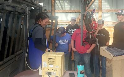Olivia Amundson, SDSU Extension Cow/ Calf Specialist, demonstrating an ultrasound machine to a group of 4-H youth.